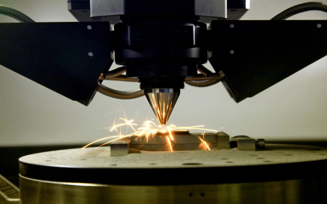 close-up of sparks flying off a 3D printer as it prints metal.